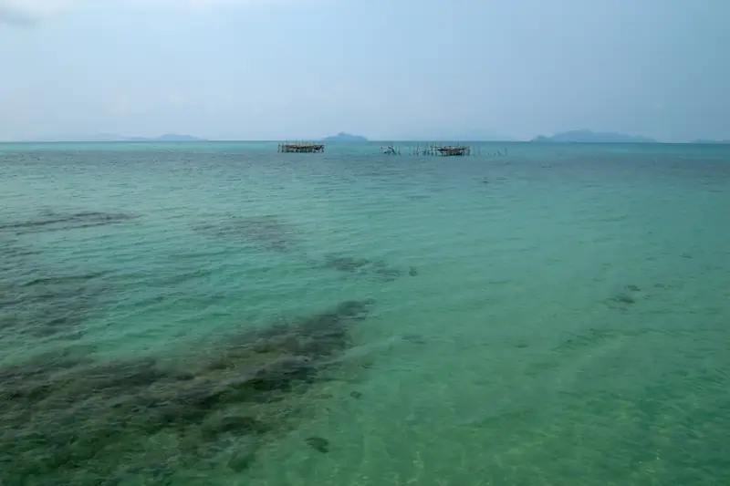 Calm turquoise lagoon water with distant islands